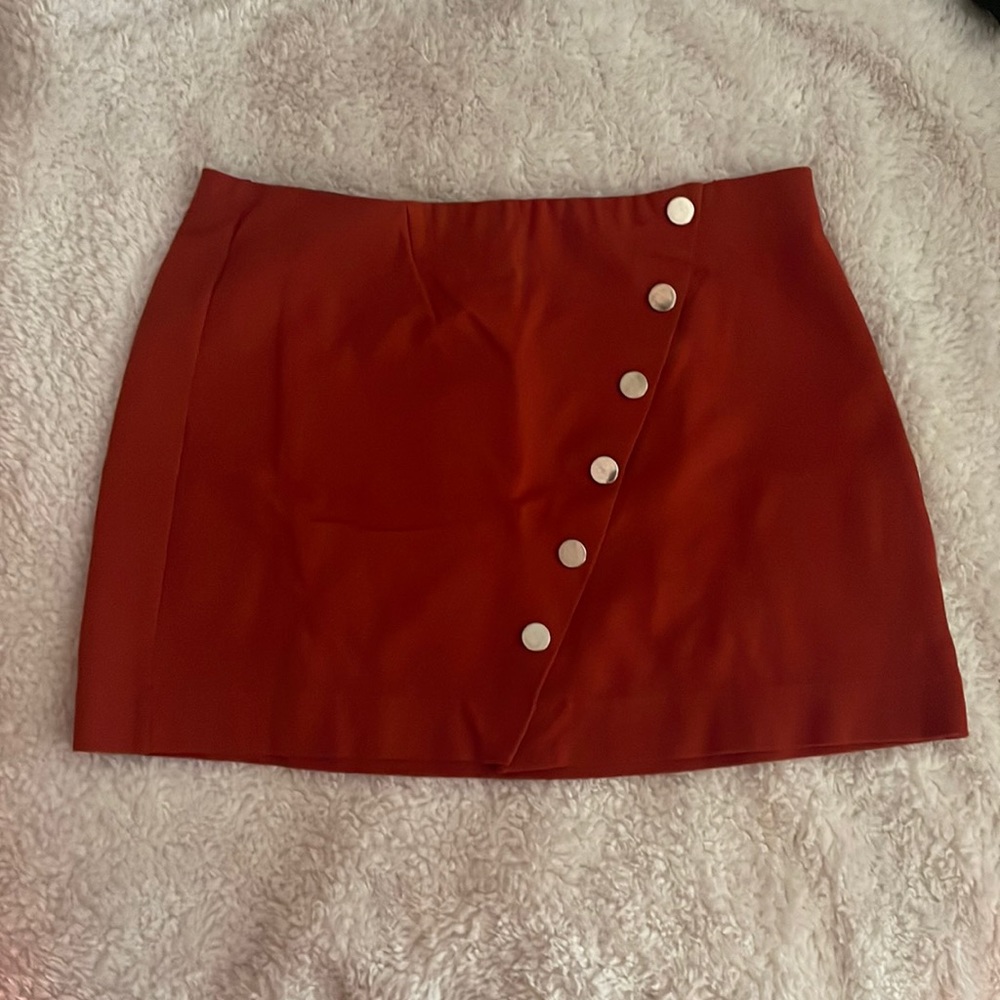 Burnt orange mini skirt with silver buttons